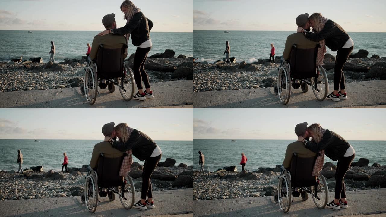 女人在海边拥抱她心爱的残疾丈夫