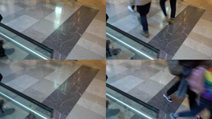 匿名人士走在购物中心，脚和大理石地板上的细节