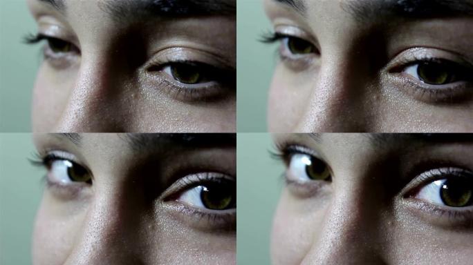 一个美丽的年轻女孩，有着绿色棕色的大眼睛，对着镜头撒娇。