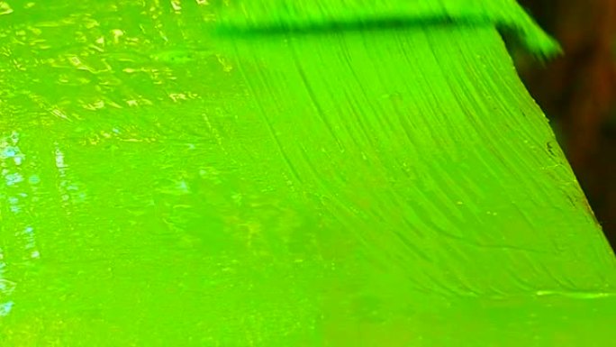 用丙烯酸绿色涂料粉刷木质表面。