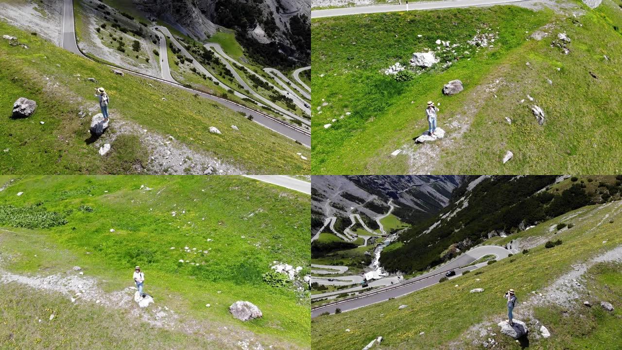 用相机拍摄年轻女性旅行癖的鸟瞰图，描绘意大利阿尔卑斯山令人叹为观止的山谷景观