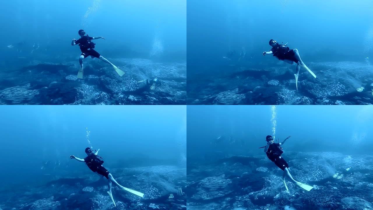 潜水员在清澈的深水中感到快乐