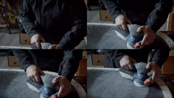 男性用研磨机打磨木板，并在木材工厂制作图案。
