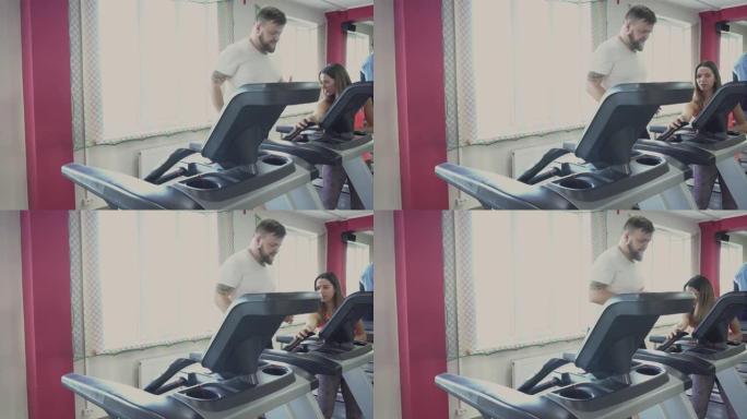 男子在健身房的跑步机上跑步。私人教练为胖子做的减肥训练。健康和健身。练习和练习。在训练前由胖人热身。