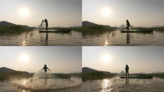 日落时渔民在湖边用船扔渔网的轮廓。概念渔夫的生活方式。泰国华富里。