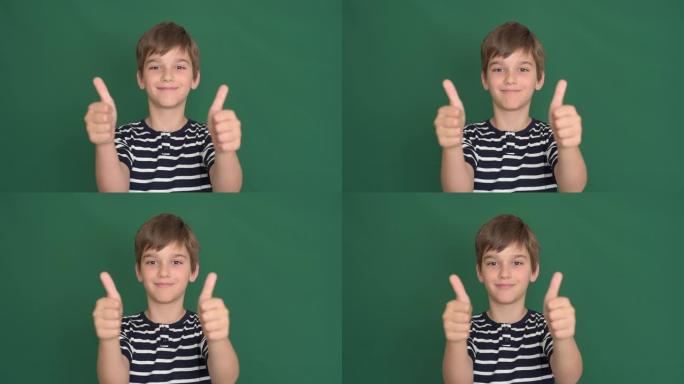绿色屏幕上竖起大拇指的小男孩