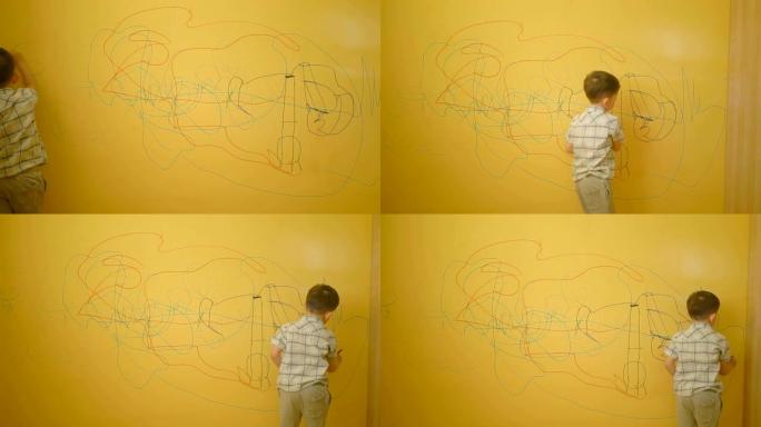 男孩在家里的黄墙上画画