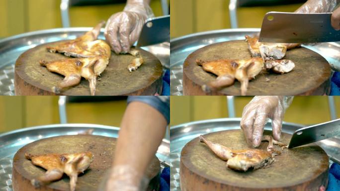 将雄性手切碎在木制砧板上的脆皮烤鸡
