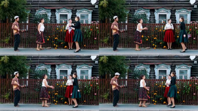 年轻妇女在音乐的村庄的街道上跳舞