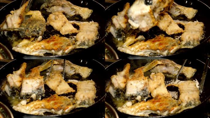 河鱼鲤鱼，切成块，用食用油在锅中油炸。