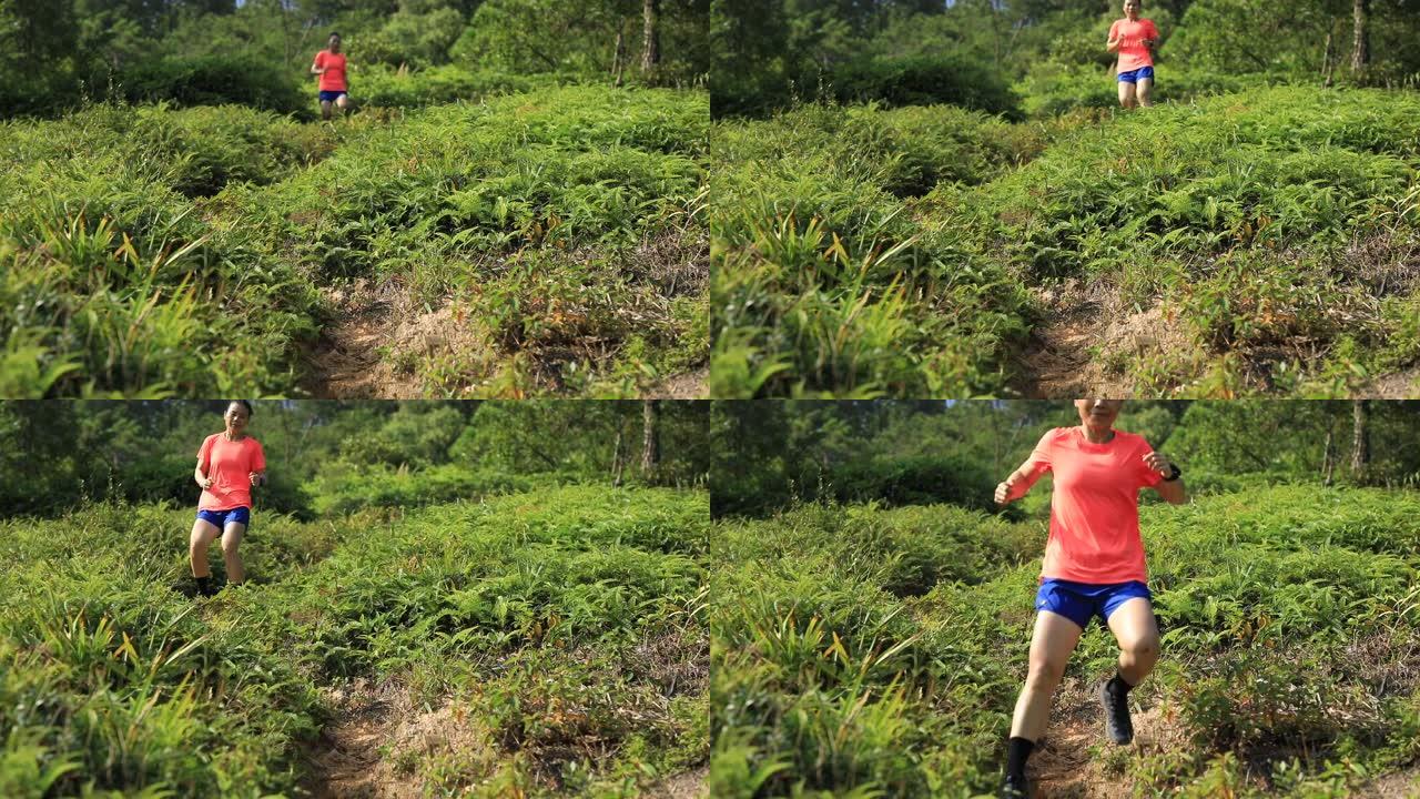女子超级马拉松运动员在热带雨林的山坡上奔跑，慢动作