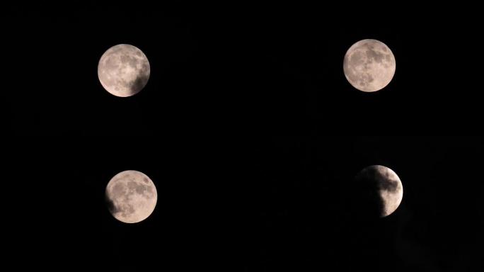 满月在夜空中移动，没有云。特写，时间流逝。神秘的月亮从下到上移动。月光照在黑色的夜空中。