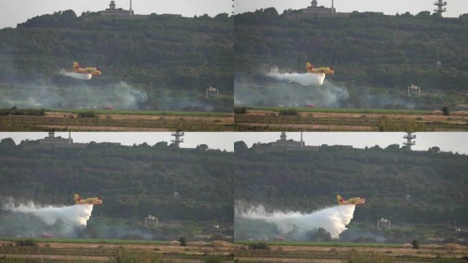 消防飞机庞巴迪将水倾倒在火上