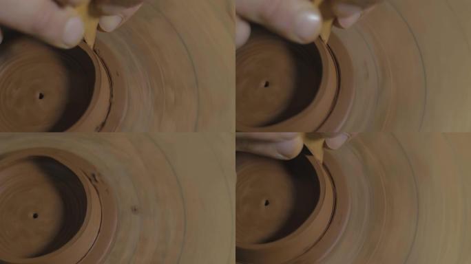 工匠用木刀从易兴粘土中取出多余的粘土作为茶壶。茶道手工制作的粘土茶壶。棕色陶器茶壶。4k视频。59.