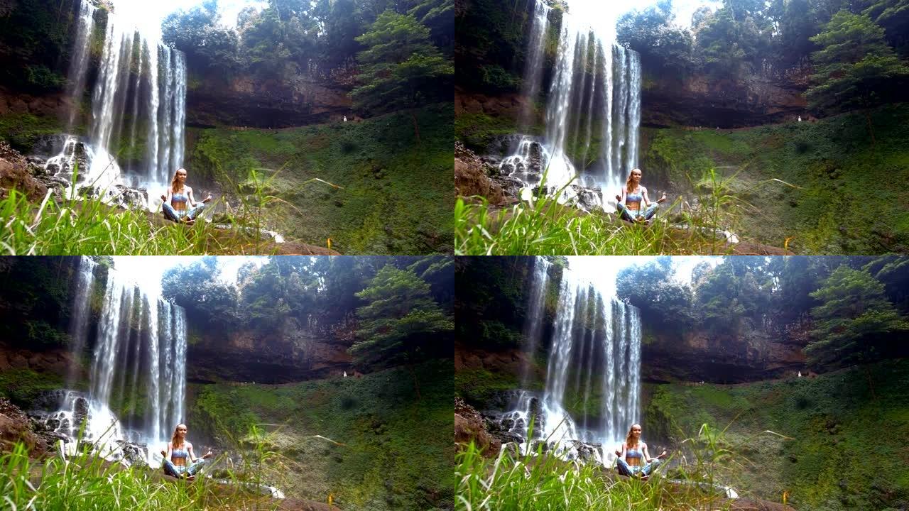 风浪草女孩在瀑布上摆出调息瑜伽姿势