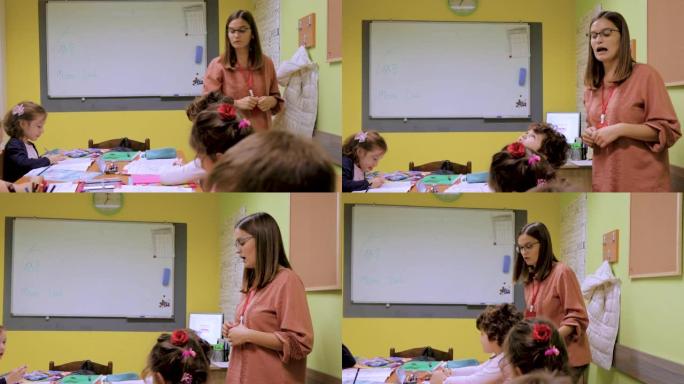 老师在外语学校向好奇的学龄前学生讲解课程