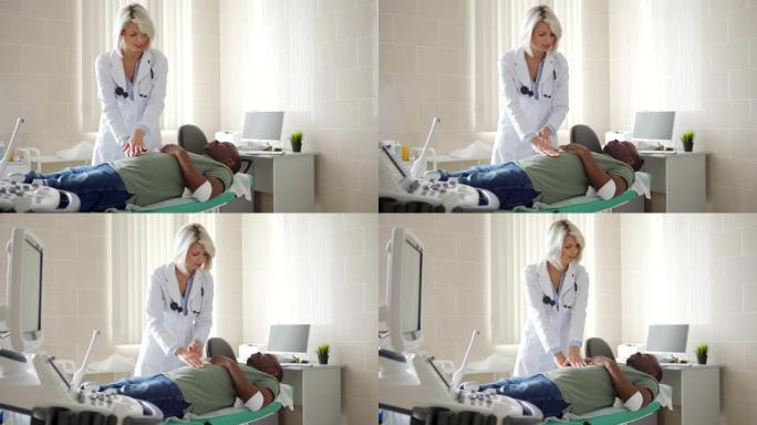 医生办公室的沙发上的静脉穿刺后，穿着白大褂的女医生的跟踪镜头触诊非洲年轻患者的腹部，手臂上缠着绷带