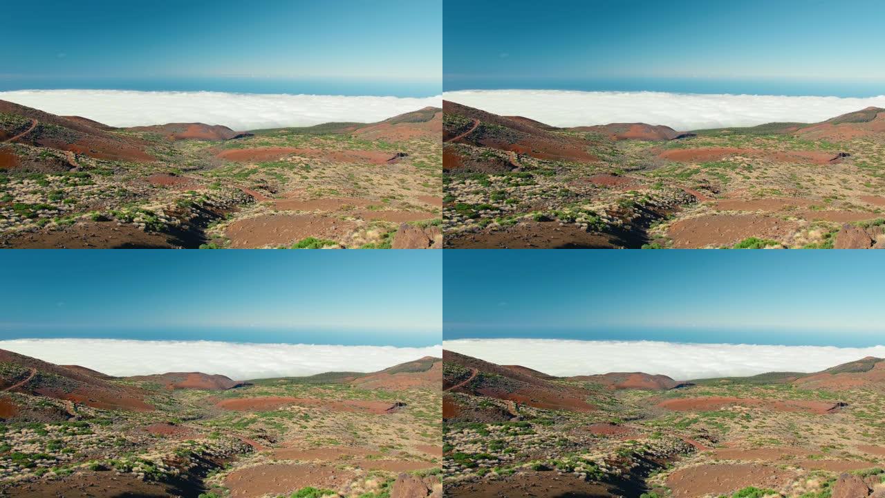 美丽的风景秀丽的加那利群岛泰德火山山景观，山脉升起在厚重的低散云笼罩之上。广角全景