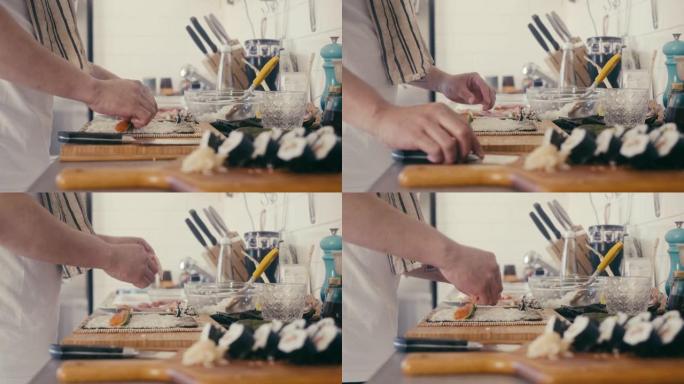 亚洲男子制作maki和寿司 (慢动作)