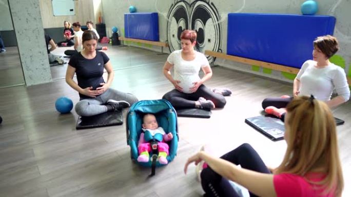 一组孕妇与教练一起训练健身