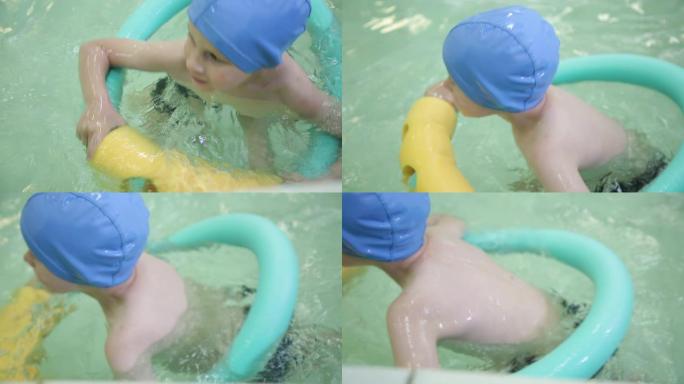 游泳池里有橡胶圈的男孩。女婴漂浮在游泳池的橡胶圈上。