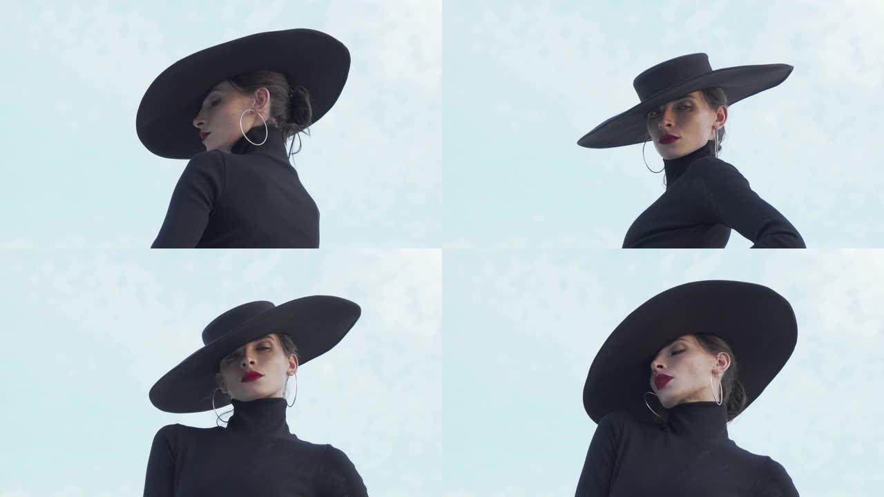 美丽的神秘女人戴着红唇和黑色帽子看着镜头