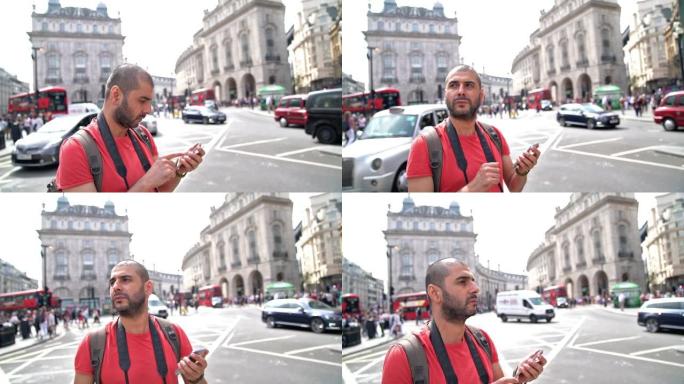 成年男子在英国伦敦街头使用智能手机的慢动作视频