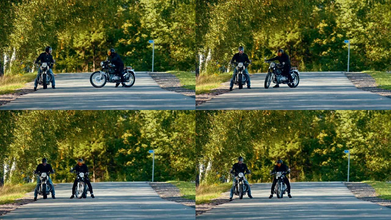 两名残忍的男子摩托车手相互站在马路上，为比赛做准备