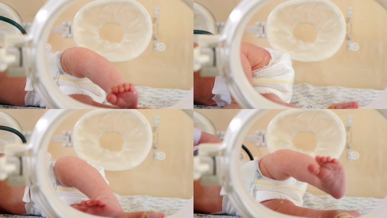 婴儿健康的概念。医院里新生儿的脚。抢救救护车中早产儿的保温箱。新生儿的强化治疗。产妇之家的医疗设备。