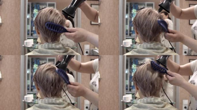 在美发师，接待处的一位美丽的年轻女子用梳子和热风电吹风进行发型设计