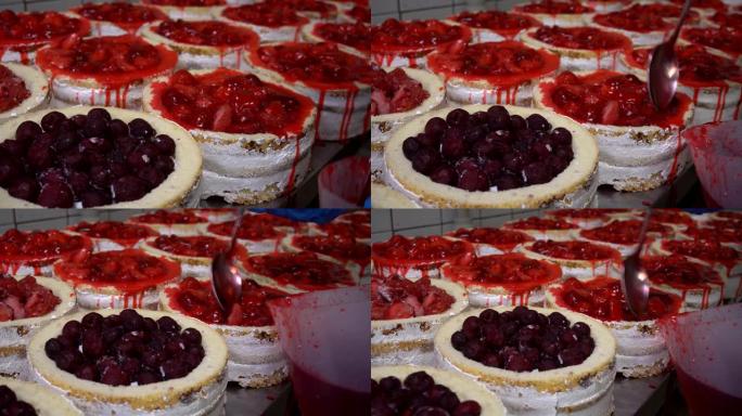 糖浆倒在带有水果和浆果的饼干馅饼或海绵蛋糕上。上釉前手工制作草莓甜品蛋糕。面粉糖果生产。