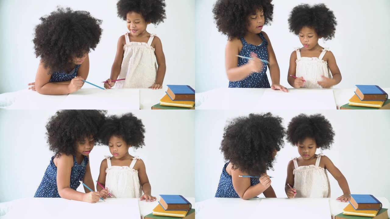 两个可爱的非洲泰国小女孩一起学习写作。大姐劝小妹怎么写