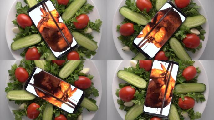 手机在盘子里，屏幕上有烤肉店整鸡。