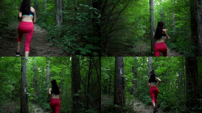 穿着红色运动裤的年轻女子在森林小径上奔跑，近景