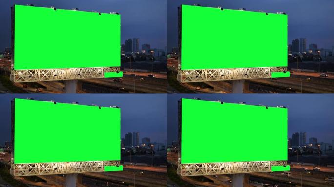 泰国曼谷城市背景下的黄昏期间，高速公路上的广告广告牌绿屏。