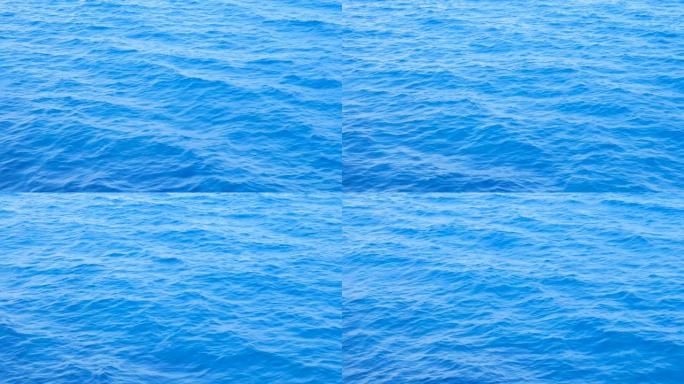 平静的大海背景。小浪的大海靠近。海水背景。蓝色的大海，小波浪纹理。深蓝色的海洋背景。海洋背景的美丽蓝