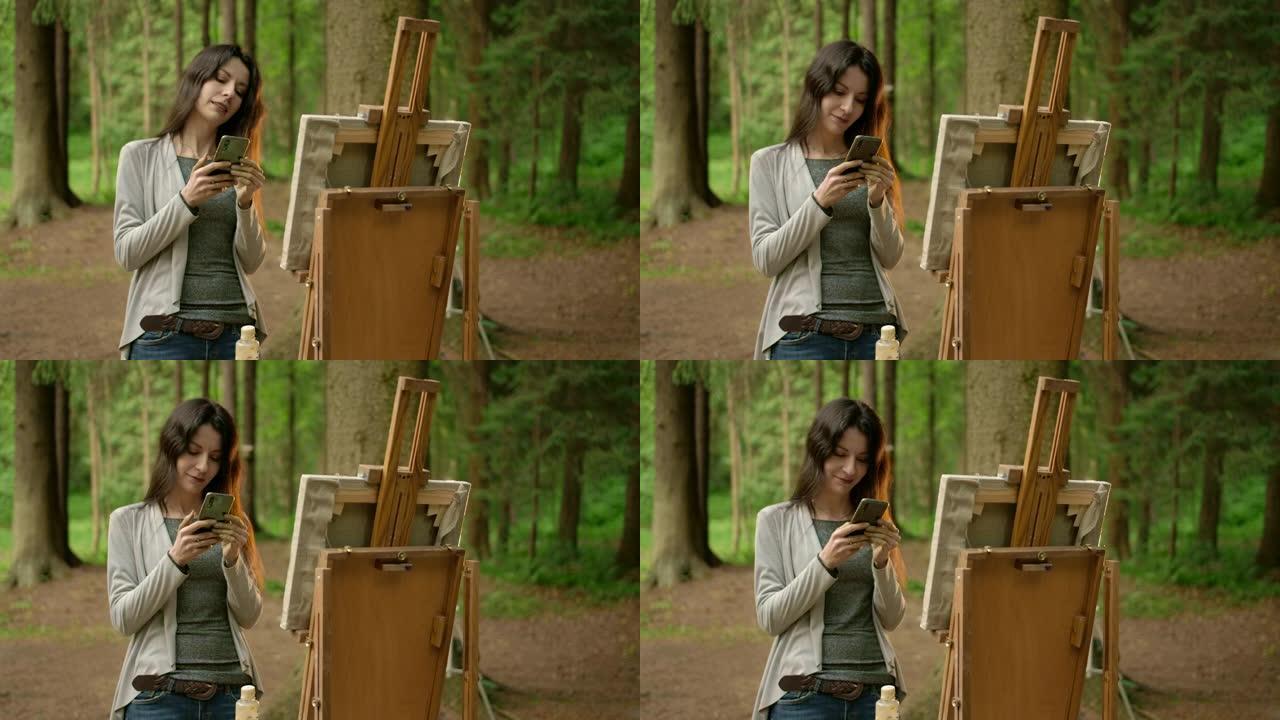 公园里拿着手机的女孩艺术家的前中框
