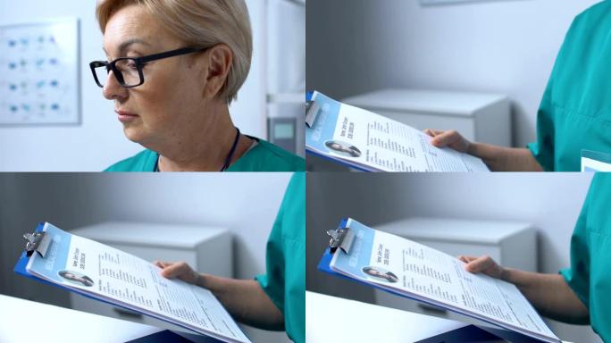 成熟的护士在笔记本电脑上工作，在患者在线医疗表格中填写数据