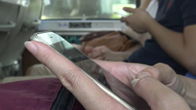 亚洲女性在公交车上使用触摸屏智能手机设备4k