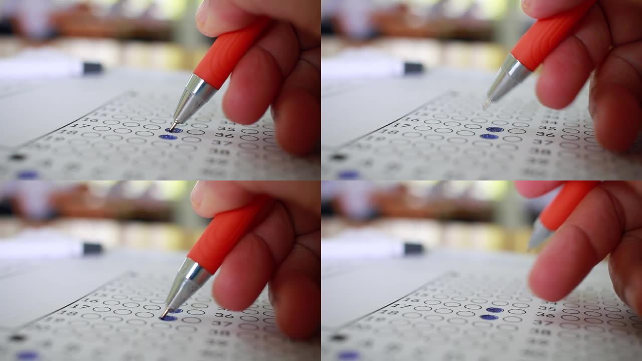 学生在练习中进行手工测试在考场的学校或大学用铅笔填写考试复写纸答题纸，在校园教室记录考试，教育或返校