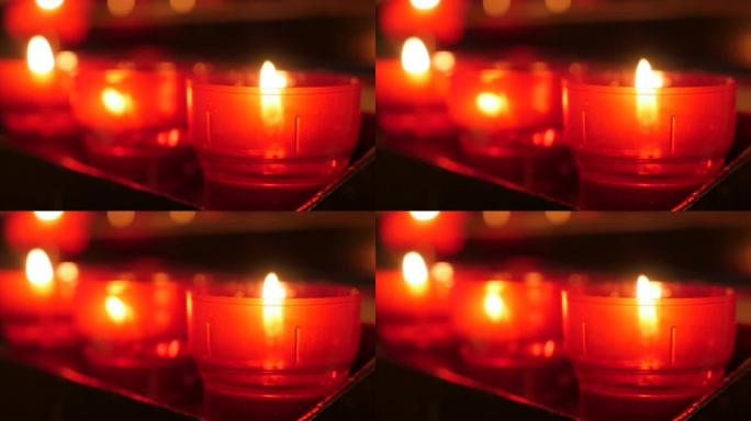 蜡烛架4k中基督教祈祷奉献蜡烛的特写