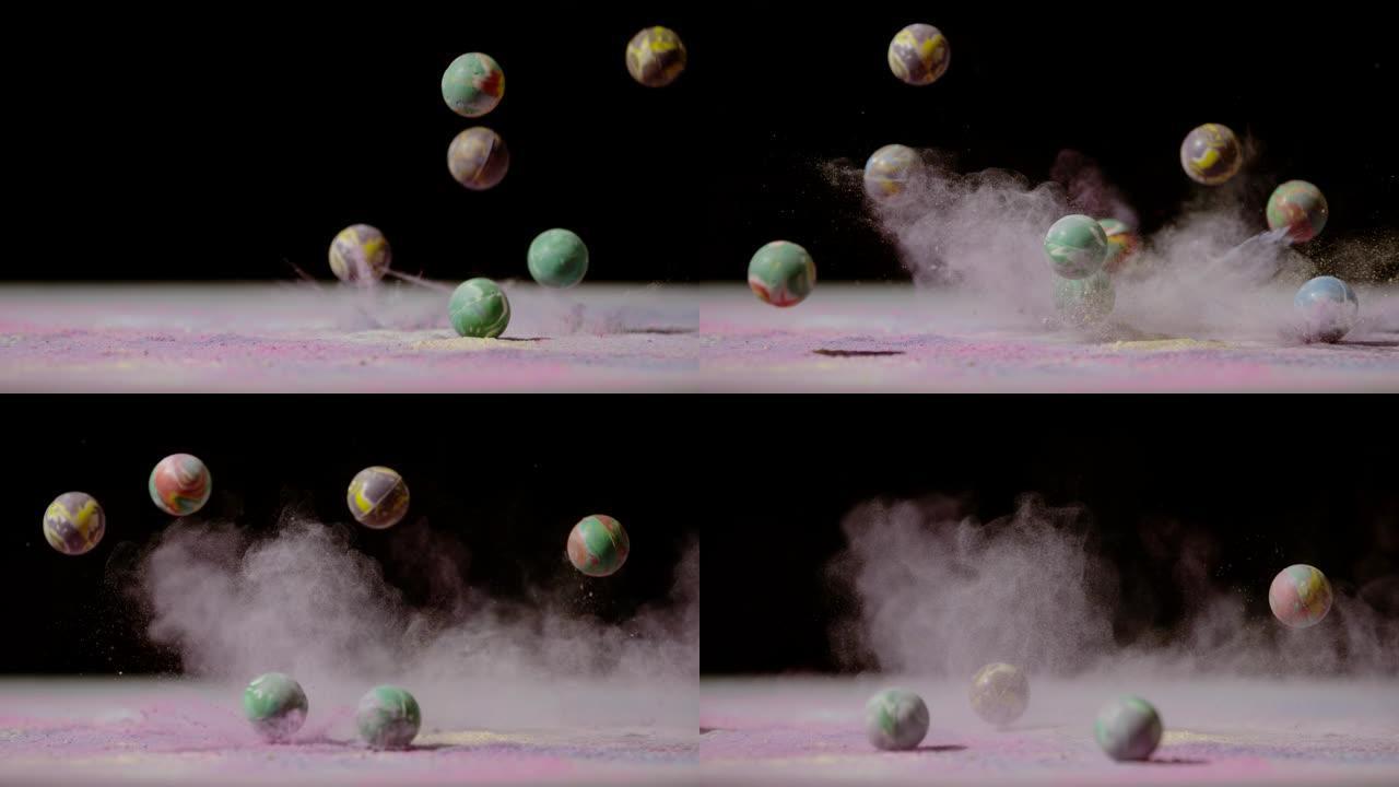 掉落在彩色粉末中的橡胶球，超慢动作