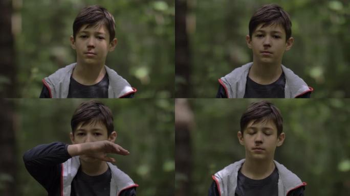 森林中一个鼻子断了的悲伤男孩的肖像看着相机，流鼻血