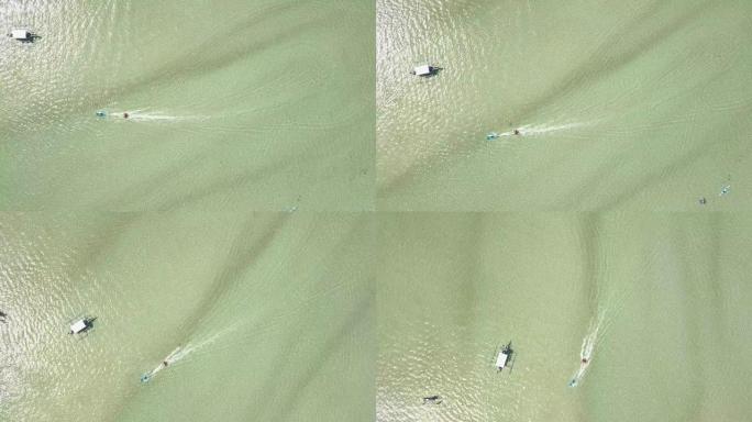 最高的无人机画面显示，一艘船在海洋中拖曳充气游乐设施。