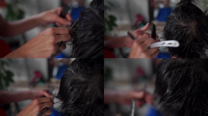 发型师的手剪断男人头发的特写镜头
