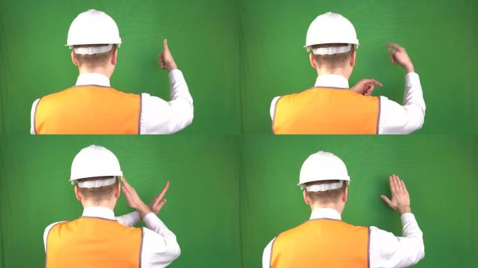 戴着防护头盔和信号背心的男性建筑商在建筑工地，安全工程，工业，hromakey展示手势命令