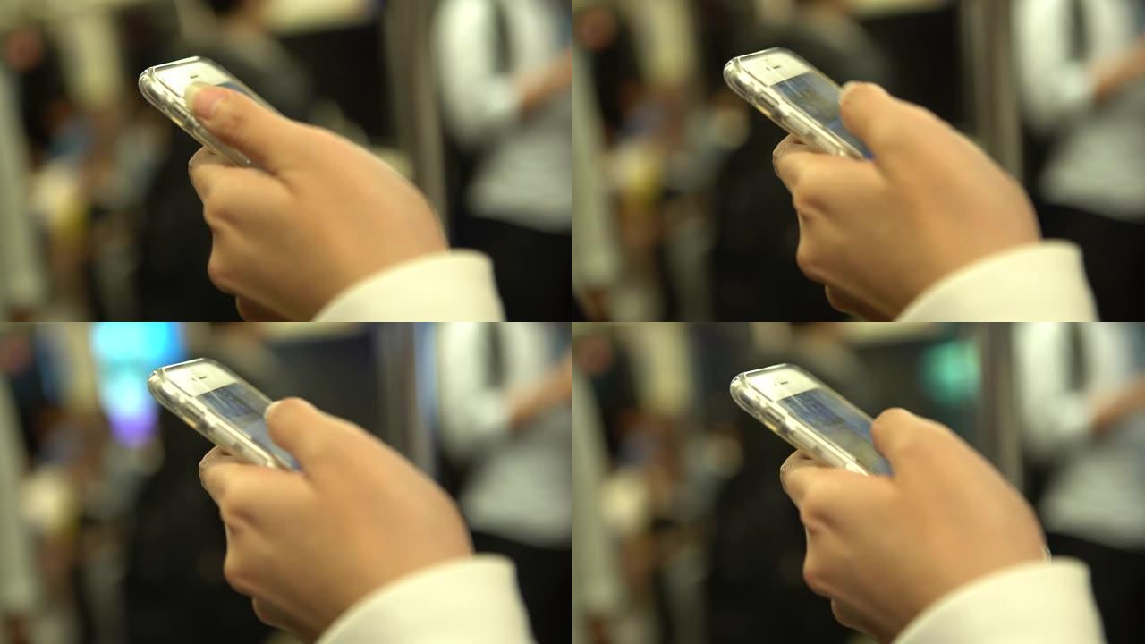 4k亚洲女子在台湾地铁使用智能手机在火车上站起来