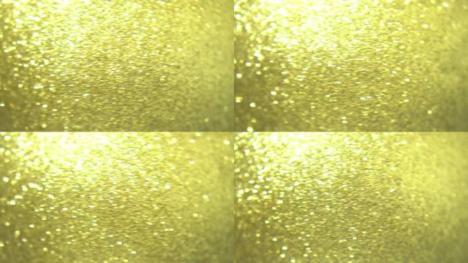 特写金色圣诞球装饰闪光和旋转背景。装饰，闪烁，闪烁，特写。模糊和软焦点。