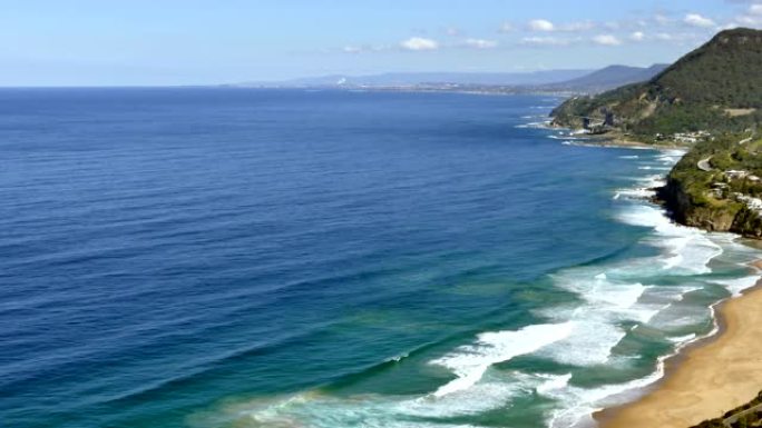 澳大利亚新南威尔士州南海岸斯坦威尔公园沙滩冲浪海滩、海岸线和海崖桥的高架视图，股票视频