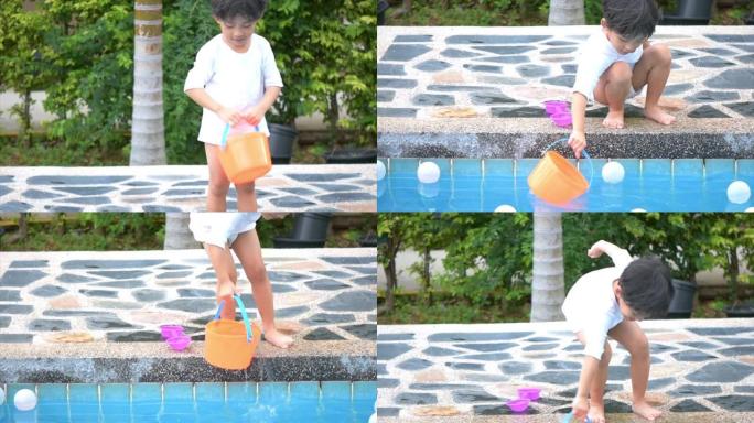 亚洲男孩儿子儿童在游泳池边玩台球玩具快乐学习生活与家庭娱乐学习和玩耍。